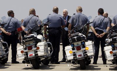 Sen. John McCain greets members of law enforcement Thursday on the tarmac prior to boarding his campaign plane in Kansas City, Mo. (Associated Press / The Spokesman-Review)