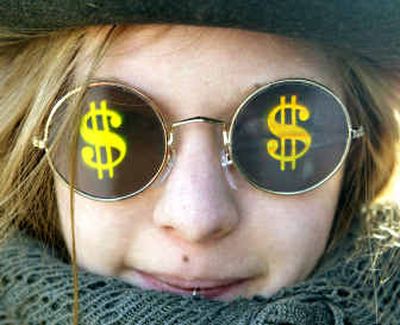 
A protester wears sunglasses with dollar signs on them during a demonstration Saturday at the World Economic Forum in Davos, Switzerland. 
 (Associated Press / The Spokesman-Review)