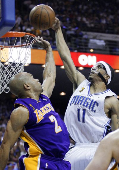 Orlando’s Courtney Lee dunks over Los Angeles’ Derek Fisher in the third quarter Wednesday.  (Associated Press / The Spokesman-Review)