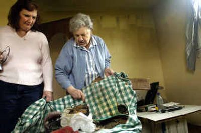 
Velma Linerud, right, and her daughter, Janelle Day, look at some of Linerud's burned possessions in the house she lived in for 50 years before a March 13 arson fire forced her to move in with Day. 
 (Holly Pickett / The Spokesman-Review)