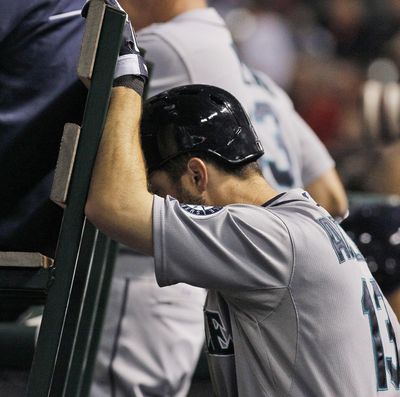 Seattle’s Dustin Ackley, 1 for 4 at the plate Saturday, hangs his head with two outs in the ninth inning of a 5-0 loss to Texas. (Associated Press)