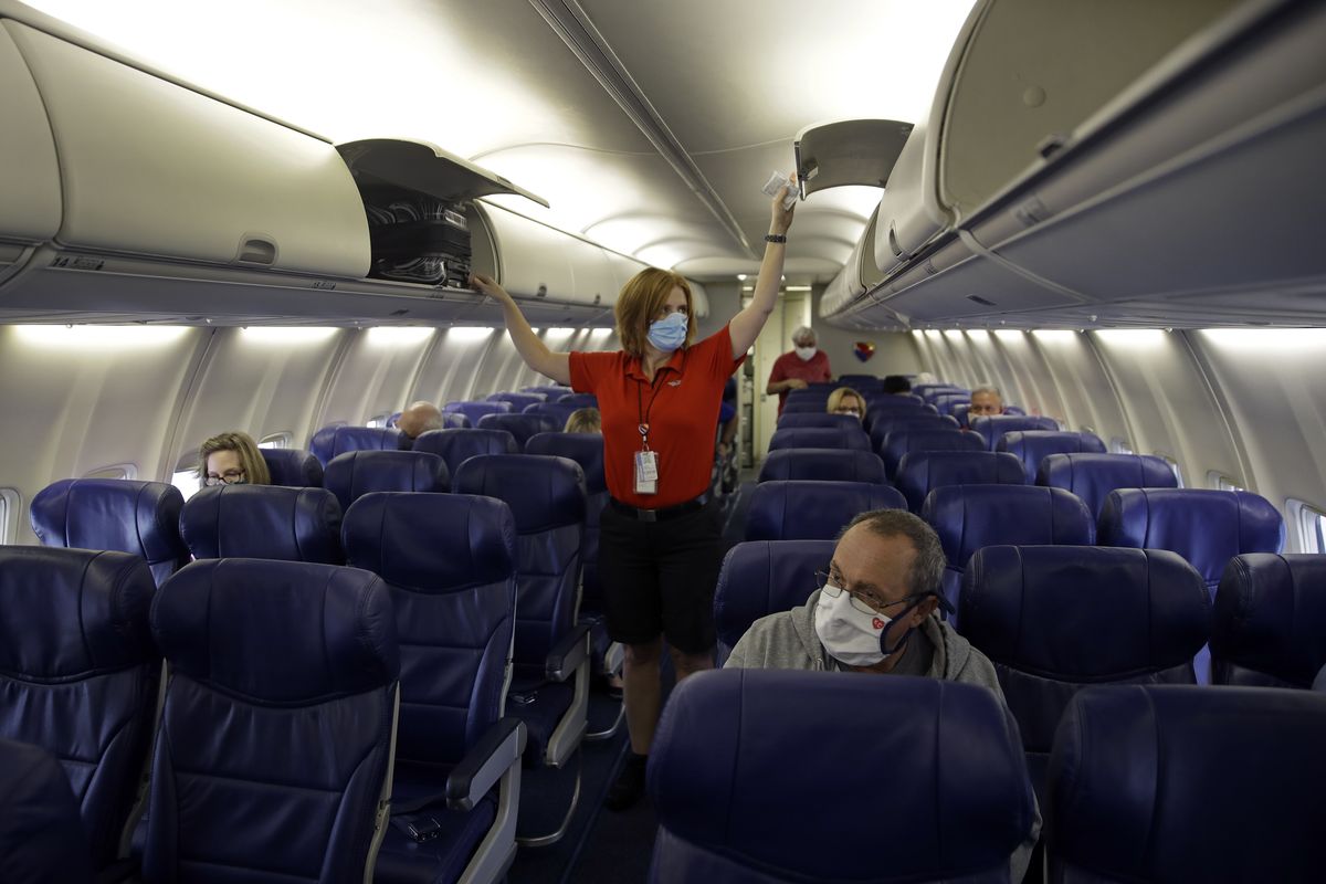 A Southwest Airlines flight attendant prepares a plane bound for Orlando, Fla., for takeoff on May 24, 2020, at Kansas City International airport in Kansas City, Mo.   (Associated Press)