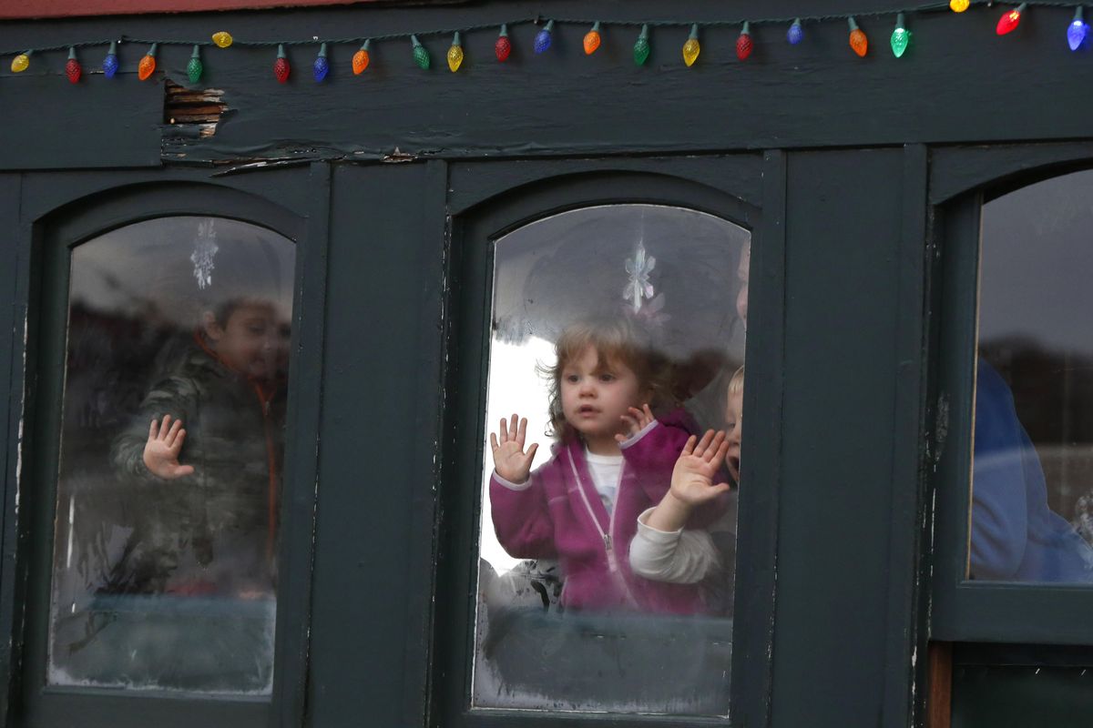 Children keep an eye out for Santa Claus as the Polar Express begins its journey to the “North Pole” on the Maine Narrow Gauge Railroad, Friday, Nov. 27, 2015, in Portland, Maine. (Robert Bukaty / Associated Press)