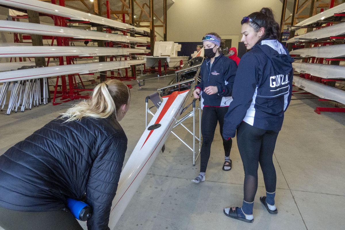Rowers Ella Beck, left, Kathleen Fisher and Sydney Bohn empty water and equipment from their two-person boat inside the recently completed Johnson Family Boathouse, the new home of Gonzaga University rowing, at Silver Lake, on the West Plains of Spokane.  (JESSE TINSLEY)