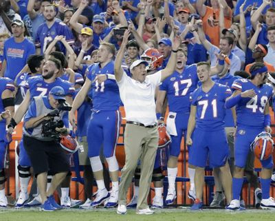 In this Oct. 6, 2018, file photo, Florida head coach Dan Mullen, center, celebrates with players on the sidelines during the final moments of an NCAA college football game against LSU, in Gainesville, Fla. Mullen opened his first team meeting this week talking about handling success. He’ll find out Saturday if anyone was paying attention. (John Raoux / Associated Press)