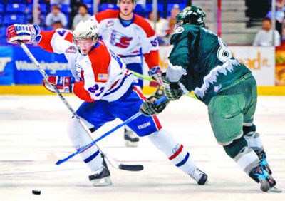 
Spokane's Drayson Bowman, left, looks to maneuver the puck past Everett defender Graham Potuer on Wednesday. 
 (Holly Pickett / The Spokesman-Review)