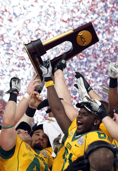 Chad Willson, left, and Warren Holloway celebrate with teammates after North Dakota State won its first FCS national championship in Frisco, Texas, on Saturday. (Associated Press)