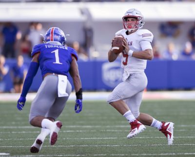 Nicholls State quarterback Chase Fourcade  scrambles away from pressure by Kansas safety Bryce Torneden  during the first quarter  in Lawrence, Kan., on  Sept. 1. (Reed Hoffmann / AP)