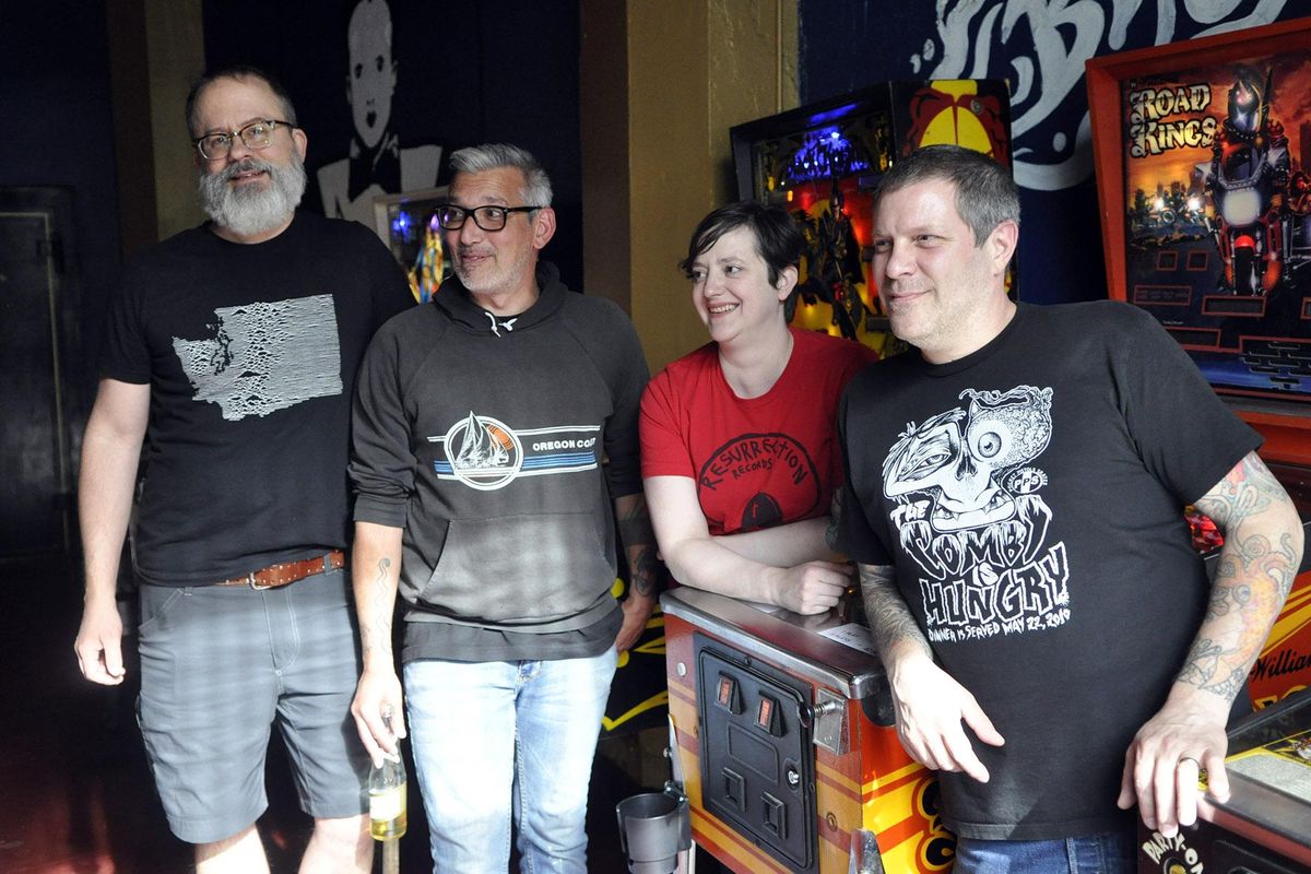 The owners of Berserk Bar pose in front of pinball machines and a mural of eccentric German singer Klaus Nomi on a recent weekday. They are (from left) Josh Davis, James Hunt and Beth and Lon McRae. (Adriana Janovich / The Spokesman-Review)