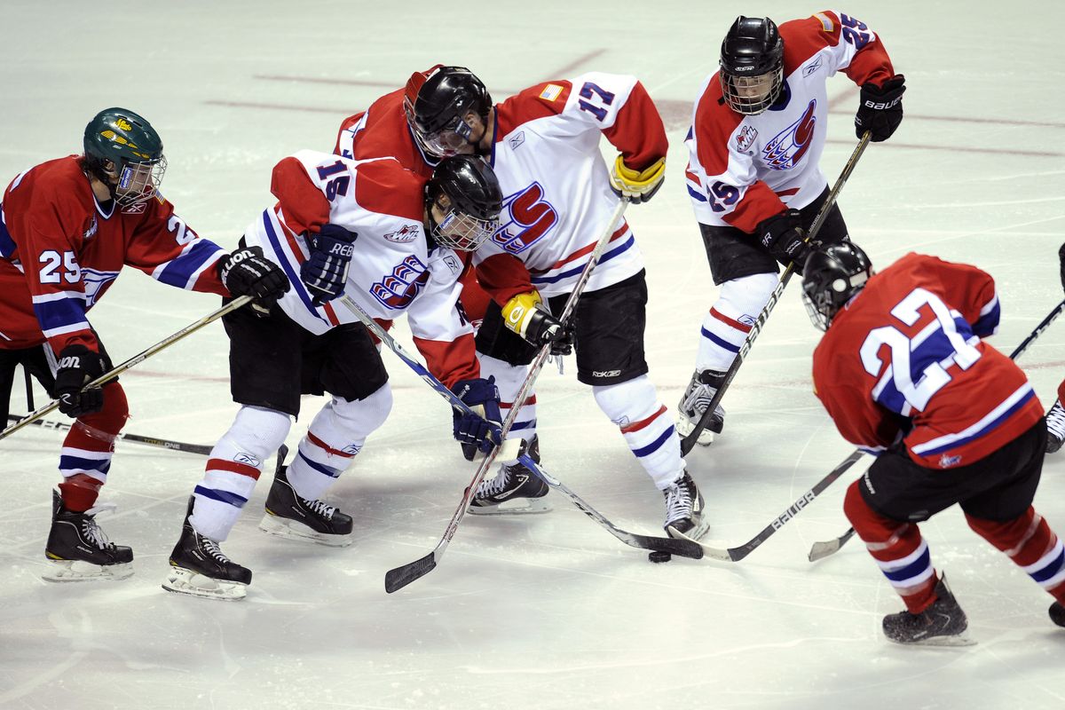 The Red and White teams battle for control of the puck during Sunday’s Red-White Scrimmage at the Arena. (Colin Mulvany)