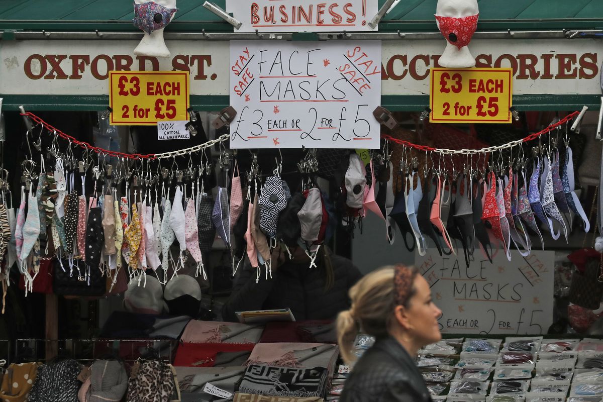 A shop sells face masks on Oxford Street in London, Tuesday, Oct. 13, 2020. Unemployment across the U.K. rose sharply higher in August which is a clear indication that the jobless rate is set to spike higher when a government salary-support scheme ends this month and new restrictions are imposed on local areas to suppress a resurgence of the coronavirus. (Frank Augstein)