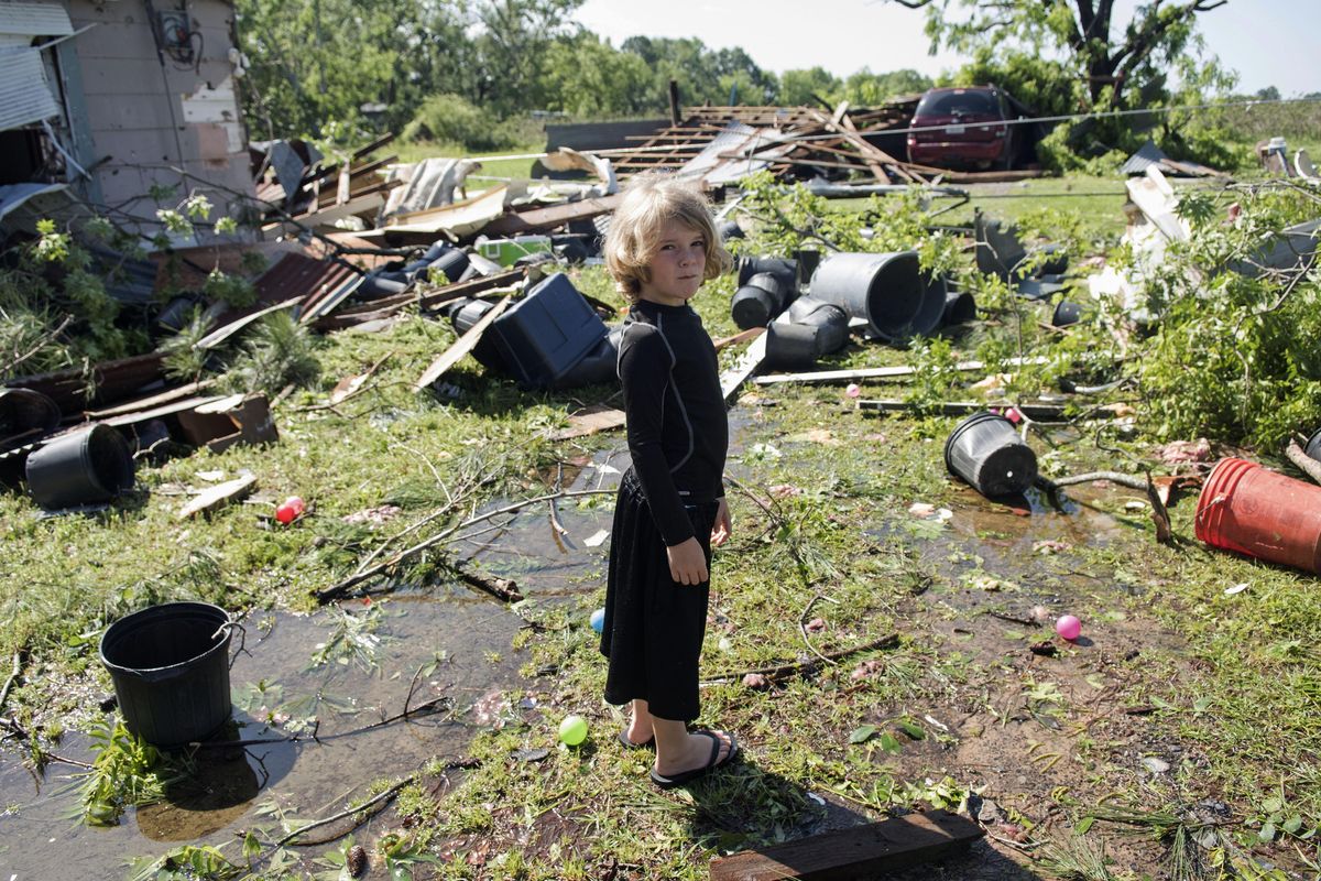 Memphis Melton, 7, looks at the destruction in his aunt’s backyard Saturday in Lindale, Texas. A suspected tornado came through the area Friday night. (Sarah A. Miller / Associated Press)