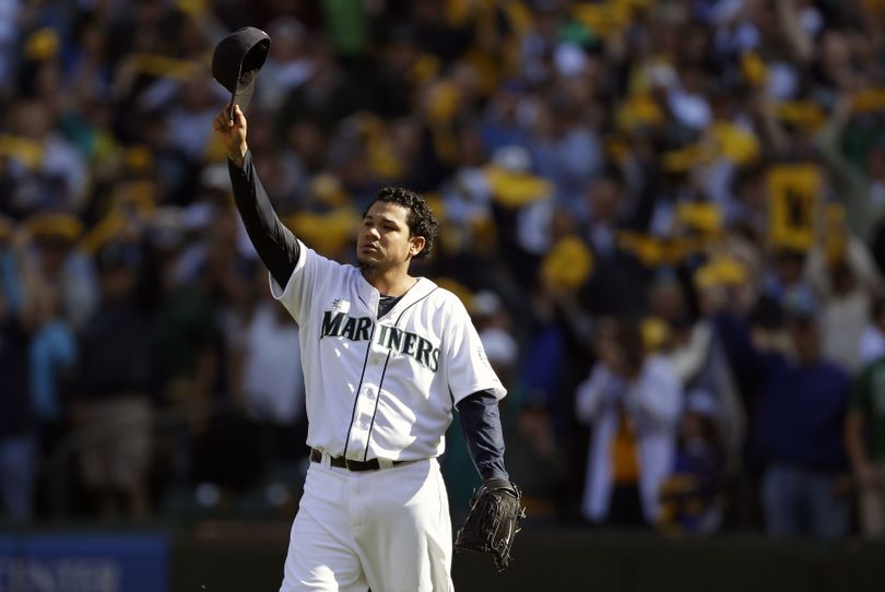 Felix Hernandez tips his cap to the crowd as he leaves during the sixth inning with the A.L. ERA title but without a postseason berth. (Associated Press)