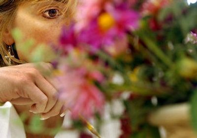 
Pam Pace of Liberty Lake judges the 4-H gardening and horticulture category at the Kootenai County Fairgrounds on Monday. 
 (Kathy Plonka / The Spokesman-Review)