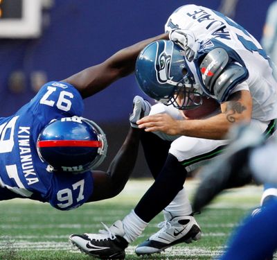 Giants defensive end Mathias Kiwanuka sacks Seahawks backup quarterback Seneca Wallace in the fourth quarter. (Associated Press / The Spokesman-Review)