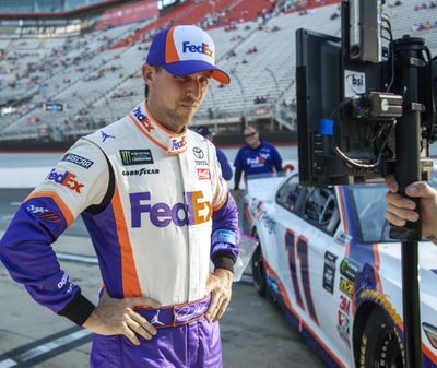 Denny Hamlin watches a television monitor as the last car qualifies for the NASCAR Cup Series auto race, Friday, Aug. 16, 2019, at Bristol Motor Speedway in Bristol, Tenn. Hamlin won the pole for Saturday night’s race. (David Crigger / Bristol Herald Courier via AP)