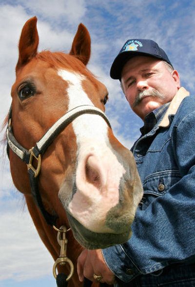 
Rene Ducroux stands next to his recently purchased ex-Boise police horse, Spatsir, last month  in Meridian, Idaho. 
 (Associated Press / The Spokesman-Review)