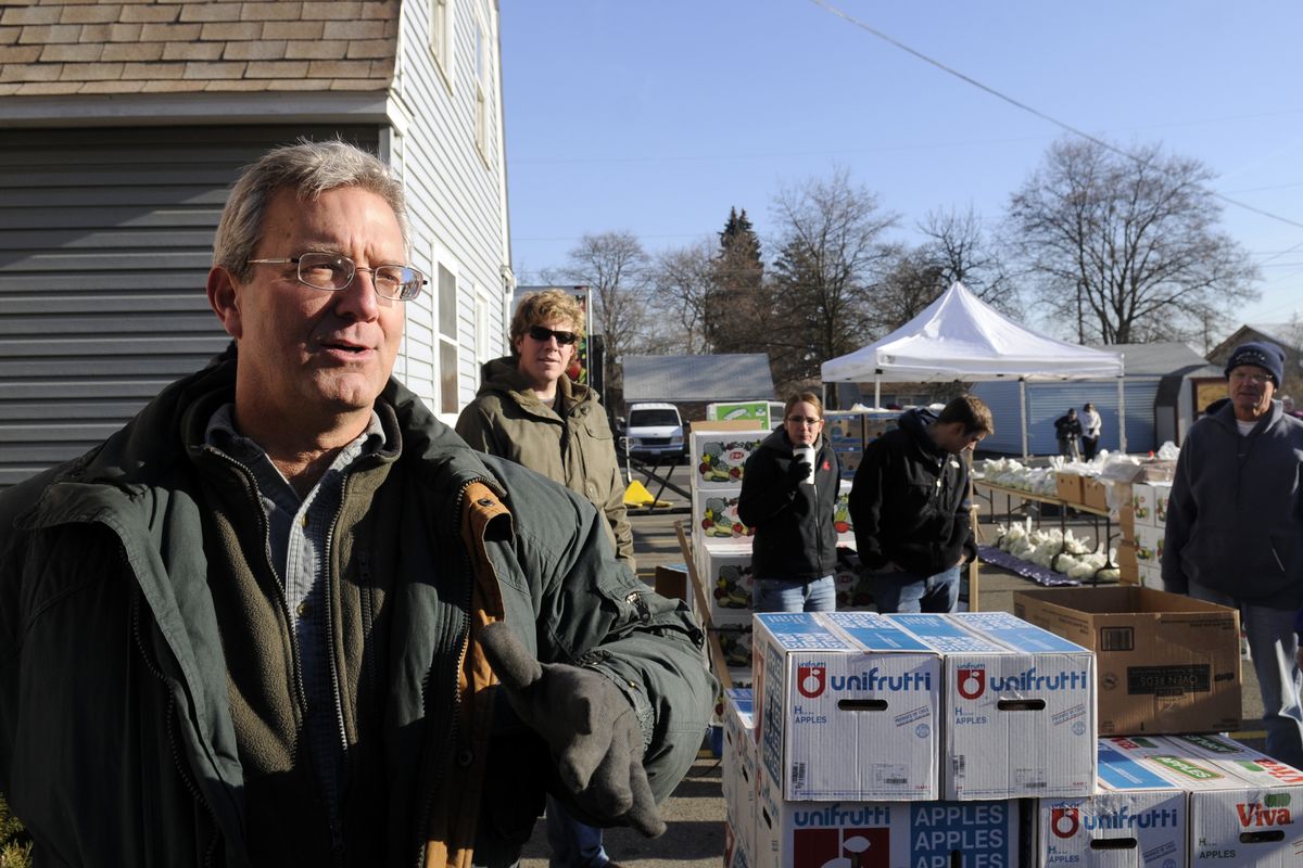 Randy Schacht, left, food safety manager for Second Harvest, briefs volunteers before they began distributing food to clients at the mobile food bank Friday, Dec. 11, 2009 at Millwood Presbyterian Church.  The church has committed to holding a food drop every month at the church.  Second Harvest provides the food when a group volunteers to hold one. (Jesse Tinsley / The Spokesman-Review)