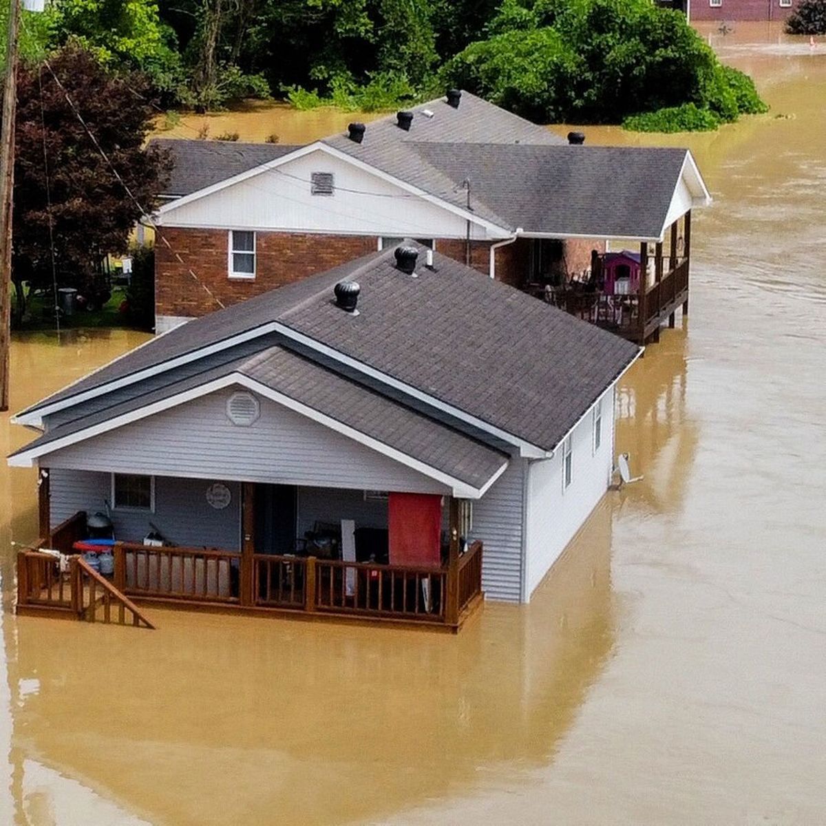 Homes on Gross Loop off Kentucky Route 15 are flooded by the swollen North Fork of the Kentucky River on July 28, 2022. MUST CREDIT: Photo for The Washington Post by Arden S. Barnes.  (Arden S. Barnes/For The Washington Post)
