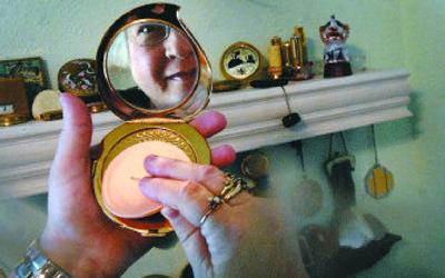 
Alice Bel has collected compacts for 10 years and has more than 200 of them displayed in the master bedroom of her north Spokane home. 
 (Jed Conklin / The Spokesman-Review)