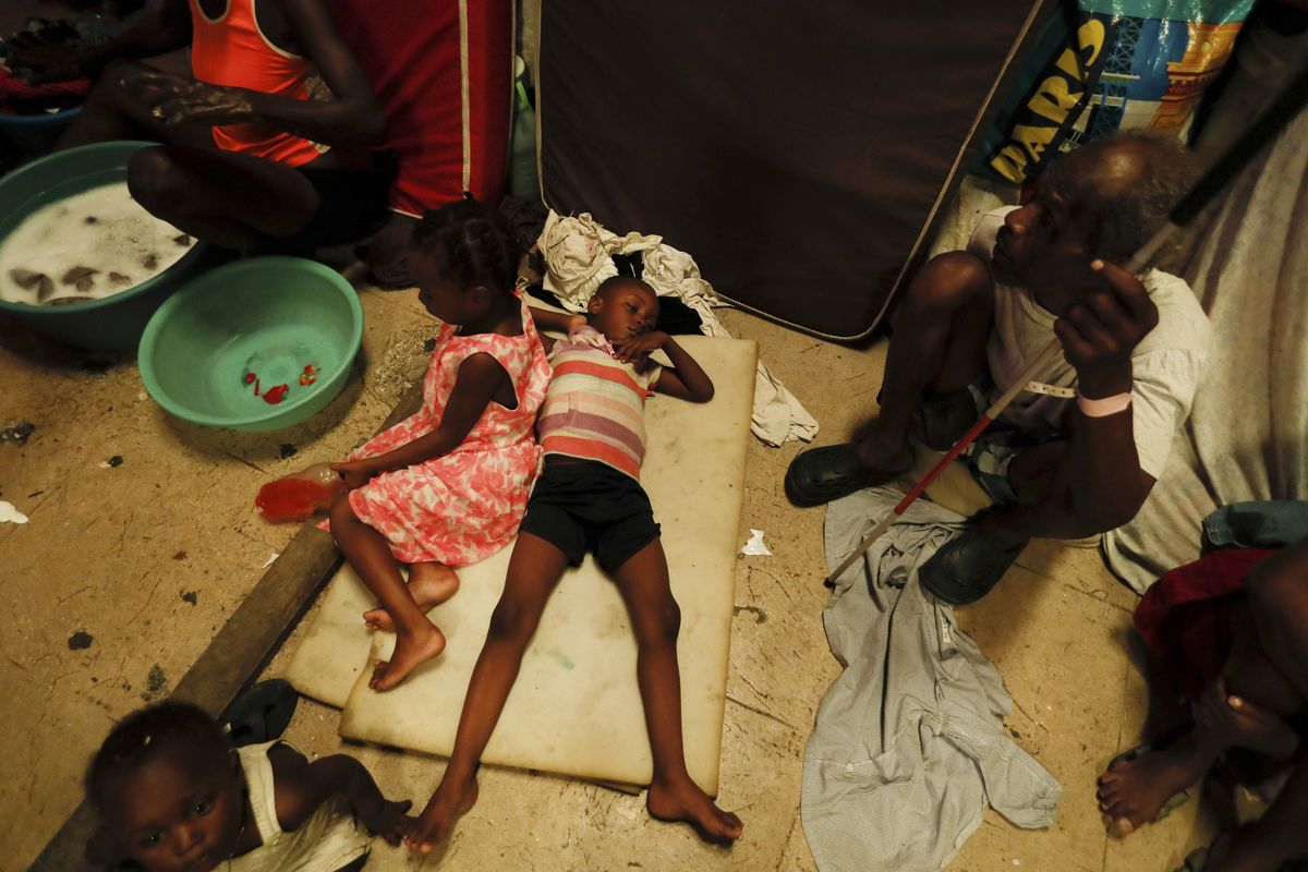 A boy lies on pieces of foam at a shelter for displaced Haitians, in Port-au-Prince, Haiti, Saturday, July 10, 2021, three days after Haitian President Jovenel Moise was assassinated in his home. The displaced Haitians were forced to flee their community where they had settled after the 2010 earthquake, after armed gangs set their homes on fire in late June.  (Fernando Llano)