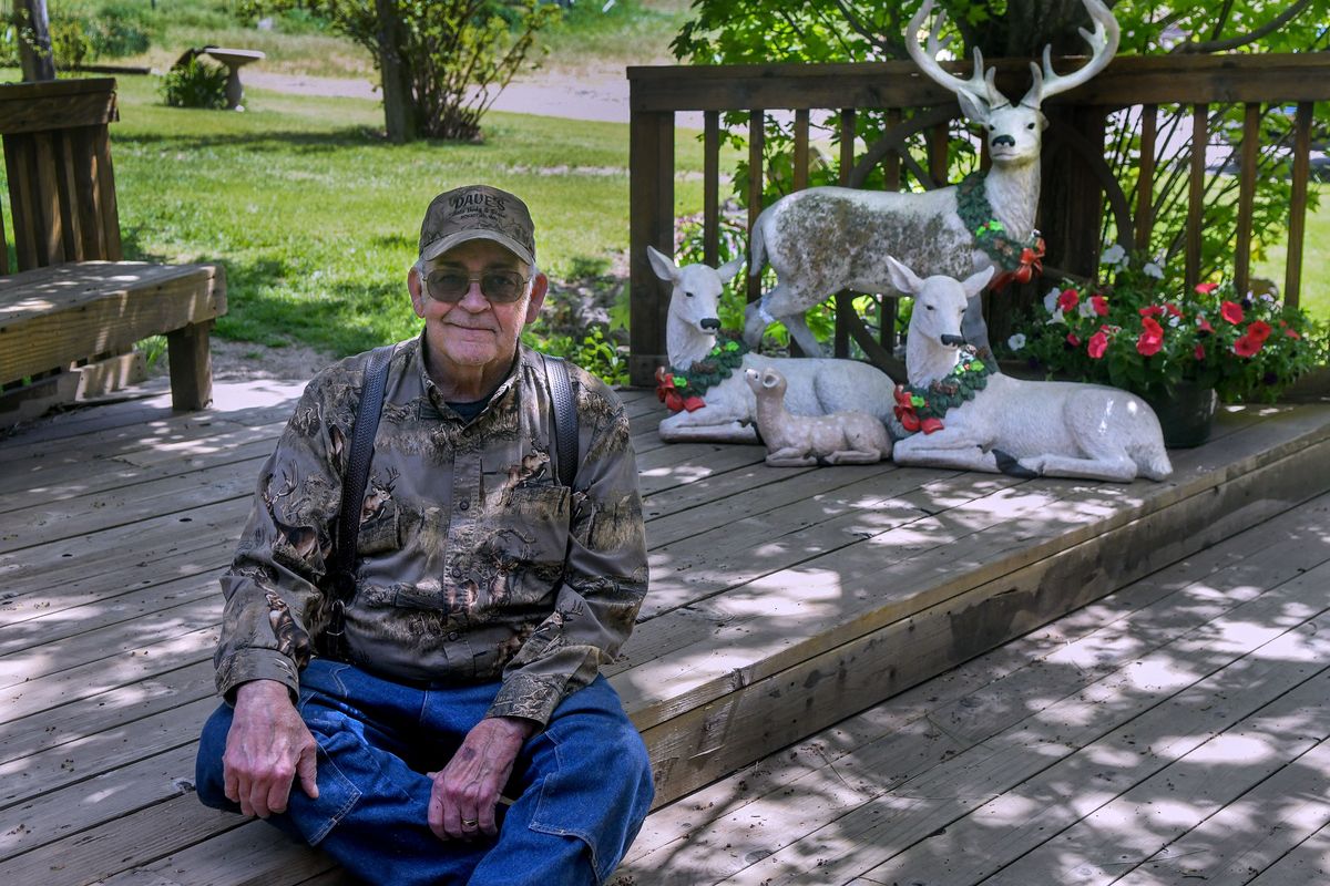 Sid Harty is photographed May 14 with deer lawn ornaments at his Valleyford home. Harty and his wife, Lynn Harty, who enjoy hunting for interesting finds as amateur pickers, refurbished the deer family find during the pandemic.  (Kathy Plonka/The Spokesman-Review)
