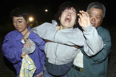 
A woman reacts to news of a relative's death after an earthquake in Kurihara, Japan, on Saturday. Associated Press
 (Associated Press / The Spokesman-Review)