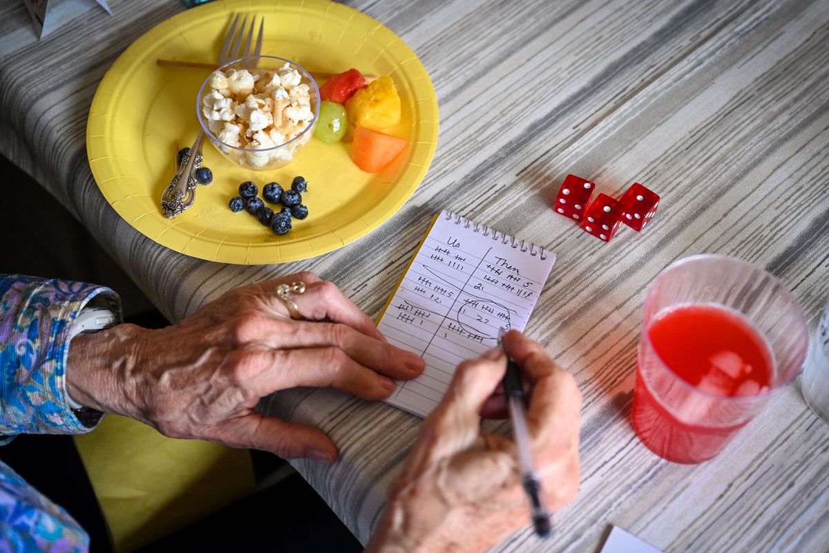 Jan George keeps track of the score at Table 3 during a bunko on April 10.  (DAN PELLE/THE SPOKESMAN-REVIEW)