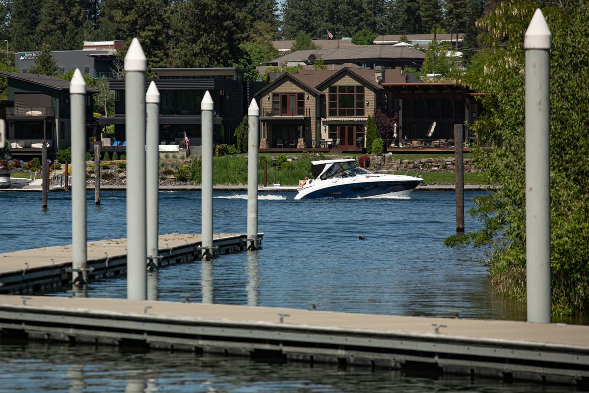 A boat cruises by the Blackwell Island boat launch Sunday in Coeur d’Alene.  (Libby Kamrowski/ THE SPOKESMAN-REVIEW)
