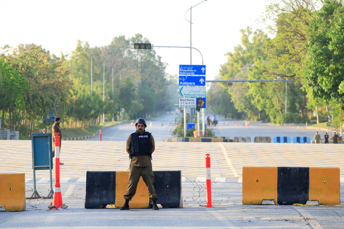 Police officers stand guard on a road leading to the Serena Hotel, as Pakistan prepares to host the U.S. and Iran for the second phase of peace talks on Tuesday in Islamabad, Pakistan.  (Reuters )