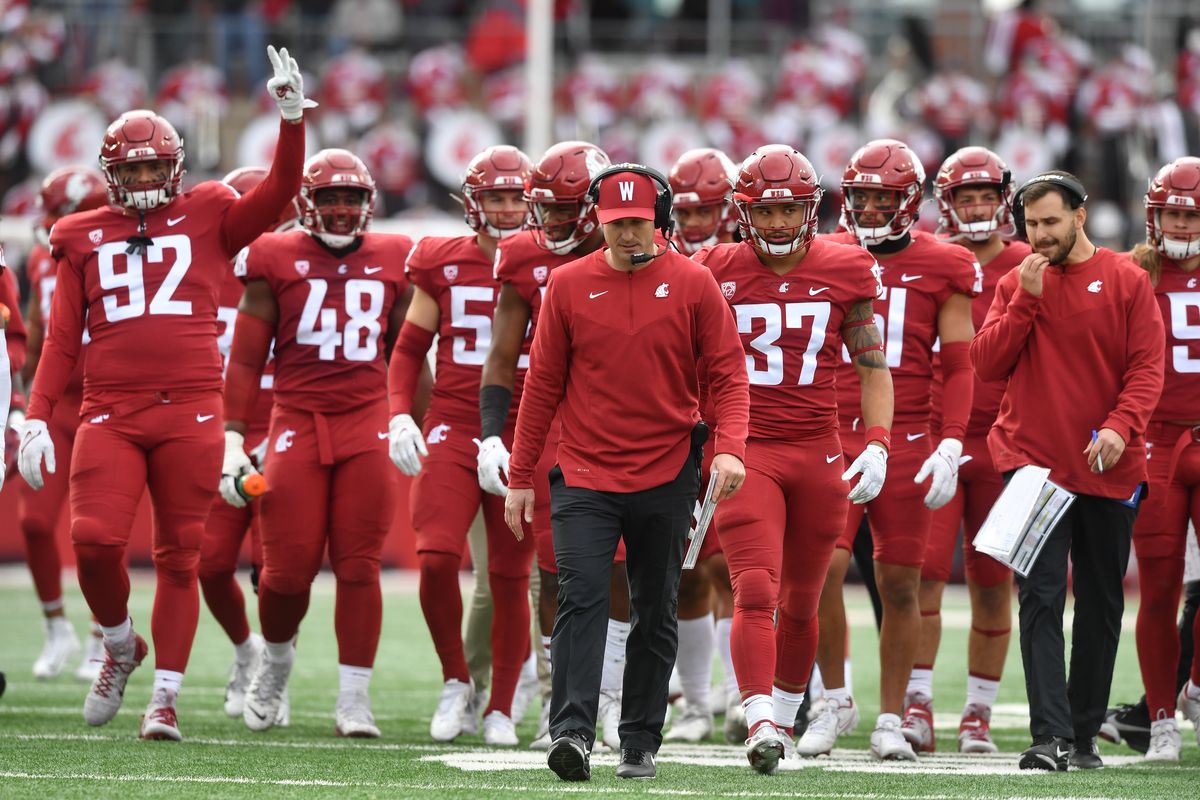 Washington State interim coach Jake Dickert walks with his team between the third and fourth quarters of their game Saturday against Brigham Young in Pullman.  (Tyler Tjomsland/The Spokesman-Review)
