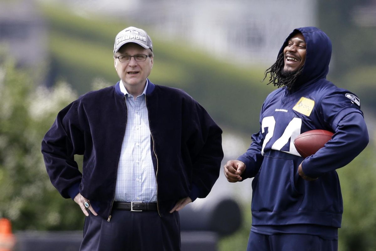 In this June 18, 2018, file photo, Seattle Seahawks owner Paul Allen, left, talks with running back Marshawn Lynch on the sidelines at an NFL football minicamp practice in Renton, Wash. Paul G. Allen, who co-founded Microsoft with his childhood friend Bill Gates before becoming a billionaire philanthropist, technology investor and owner of the Seattle Seahawks, died in October. Allen