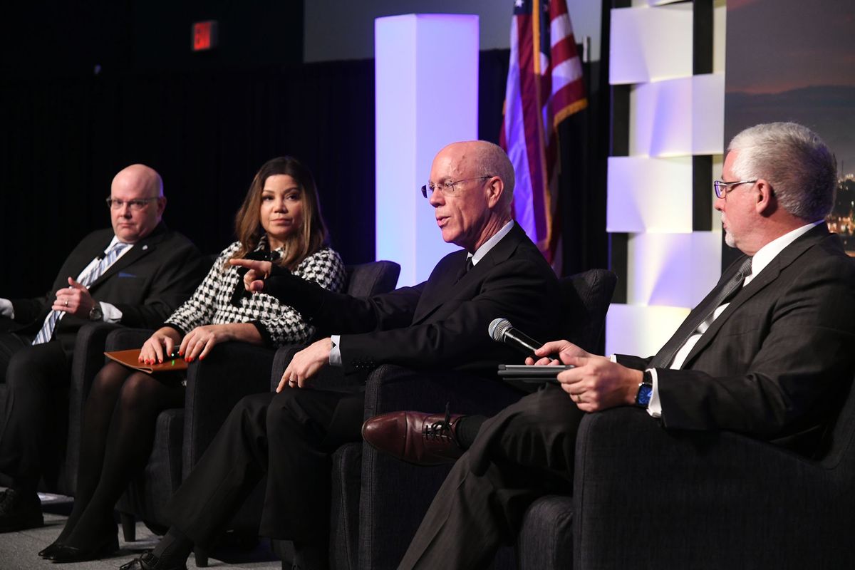 Steve Scranton, senior vice president of Washington Trust Bank, takes audience questions with local economists Grant Forsyth, left, Vange Ocasio Hochheimer and moderator Paul Reed, publisher of Spokane Journal of Business, right, at Greater Spokane Inc.