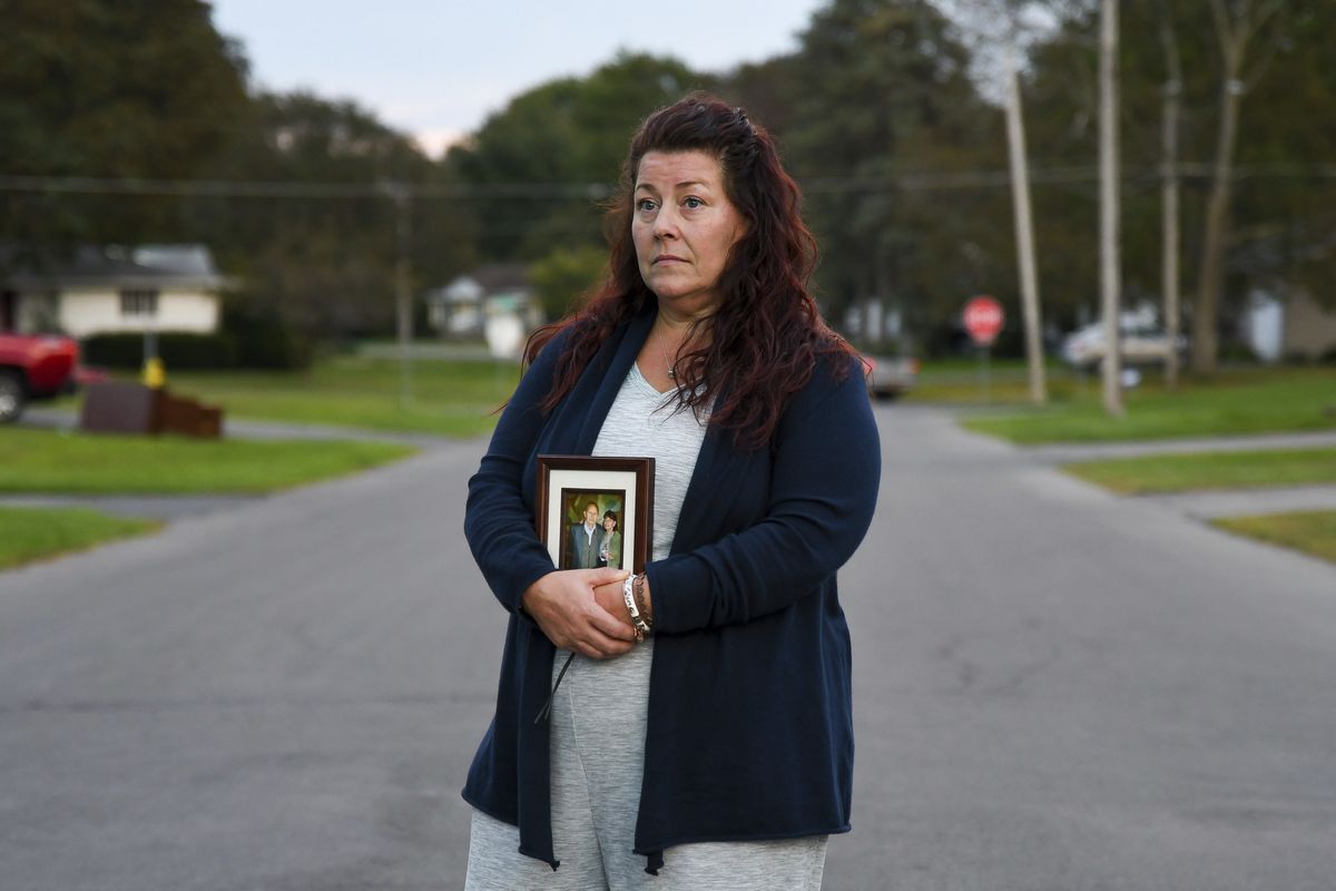 Natalie Walters, 53, holds a photo of her parents, Jack and Joey Walters, near her home in Syracuse, N.Y., Tuesday, Sept. 21, 2021. Walters