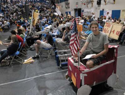 
Michigan caucus chairman Kyle Davis drives a student-built battery-operated car before the roll call during the Central Valley Mock Political Convention Tuesday.
 (Photos by J. BART RAYNIAK / The Spokesman-Review)