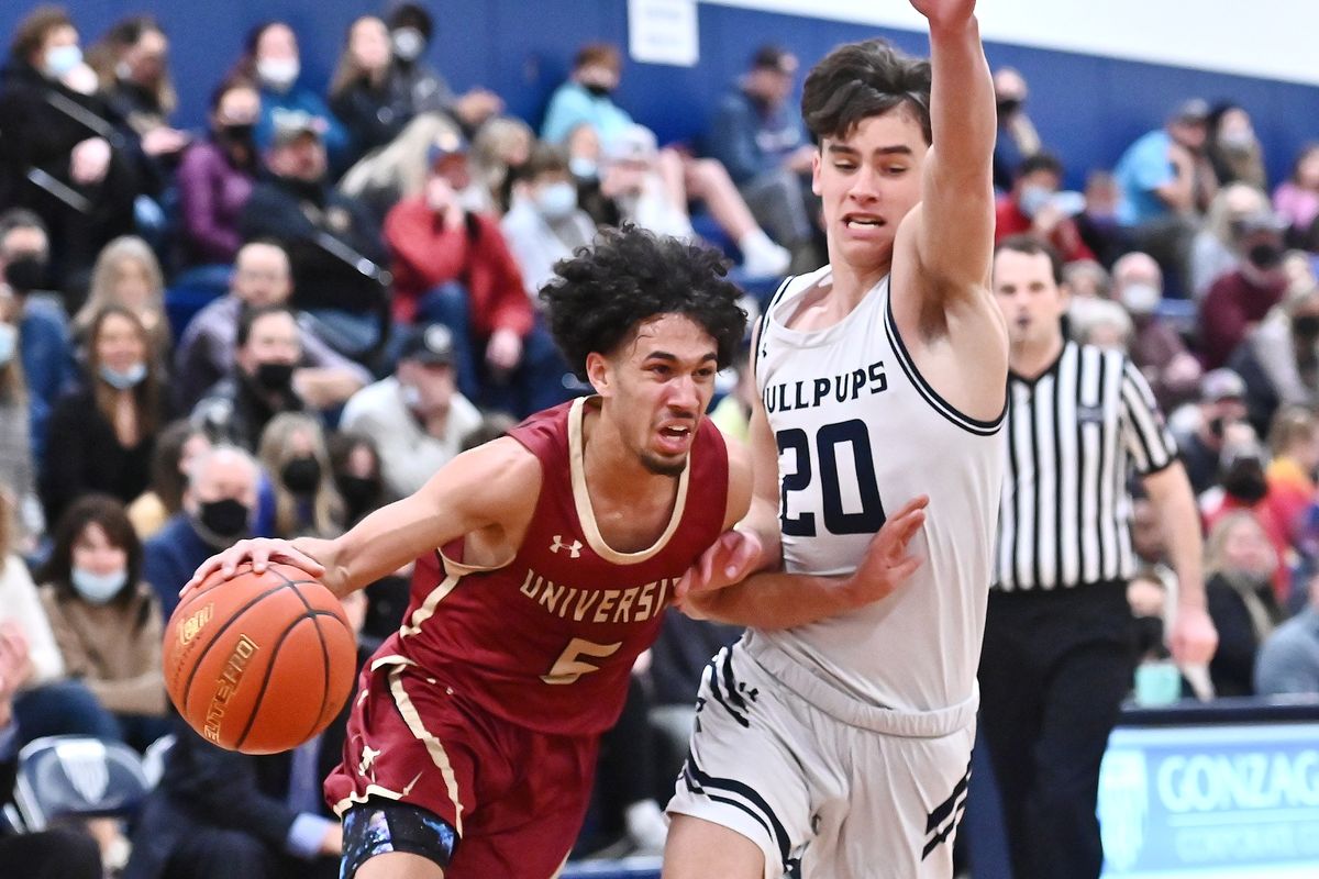 University Titians guard Jeremiah Sibley (5) runs the lane against Gonzaga Prep Bullpups guard Henry Sandberg (20) in the first half of a high school basketball game at Gonzaga Prep on Friday, Jan. 28, 2022 in Spokane WA. (James Snook For The Spokesman-Review)