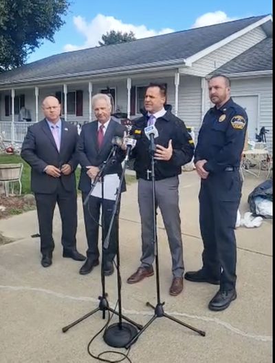 Burton Mayor Duane Haskins, Genesee Co. Prosecutor David Leyton, Sheriff Christopher Swanson and Burton Police Chief Brian Ross address the media about 57 dogs found at a home over the weekend.   (Genesee County Sheriff/TNS)