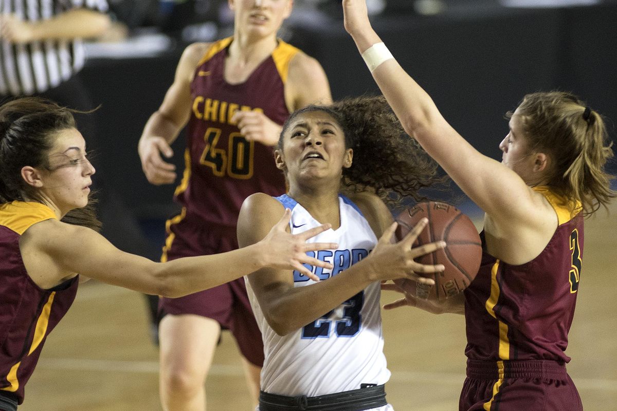 Central Valley’s Tomekia Whitman drives to the hoop past Moses Lake’s Jamie Loera, left, and Brecka Erdmann, right, during last year’s State 4A girls semifinal  at the Tacoma Dome. Central Valley won 51-33 to advance to the championship game. (Patrick Hagerty / Patrick Hagerty)