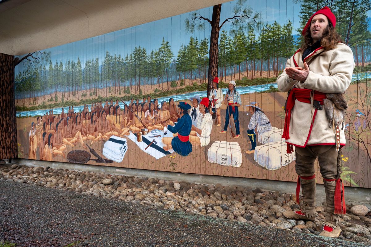 Artist Shawn Deller, dressed in the clothing of the Spokane House traders, explains Monday the murals he painted on the side of the Spokane House Interpretive Center during a program at the site of the former trading post, which was active from about 1810 to around 1825 or 1826.  (Jesse Tinsley/THE SPOKESMAN-REVIEW)