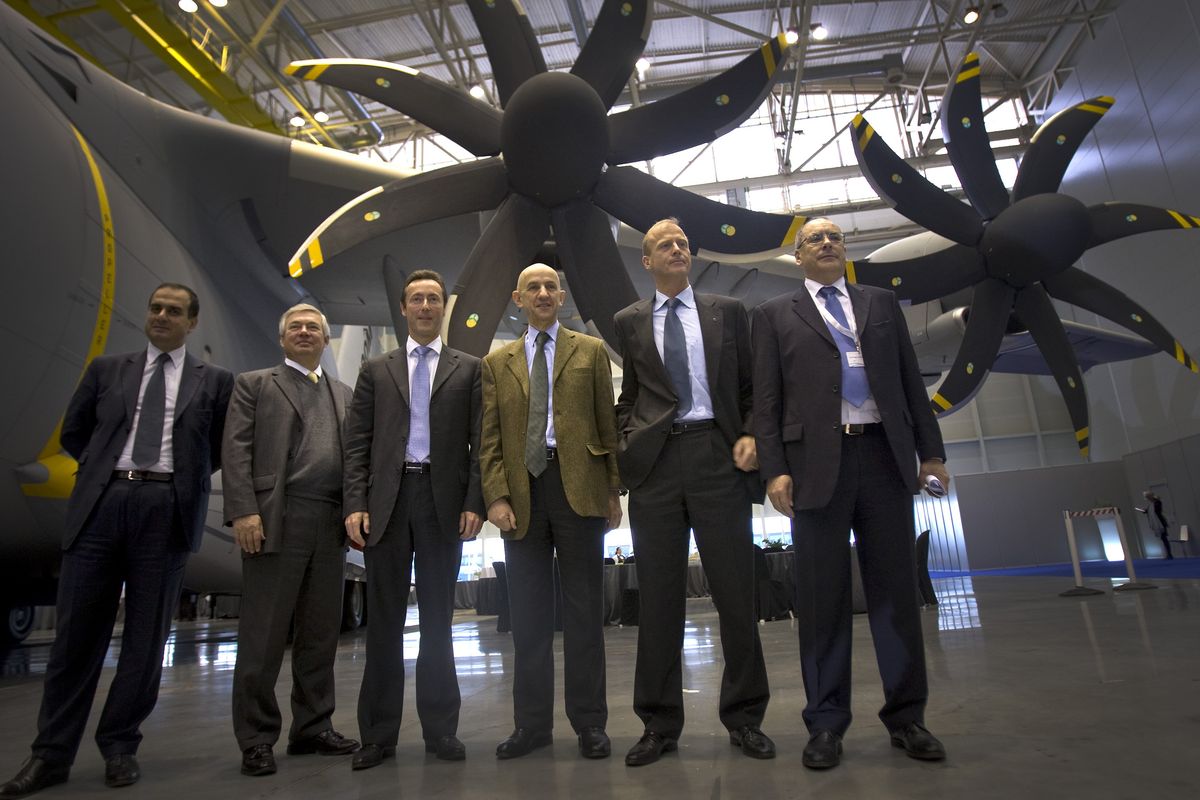 Airbus and EADS executives pose for pictures in front of the Airbus A400M military aircraft in Seville, Spain, on Tuesday.
