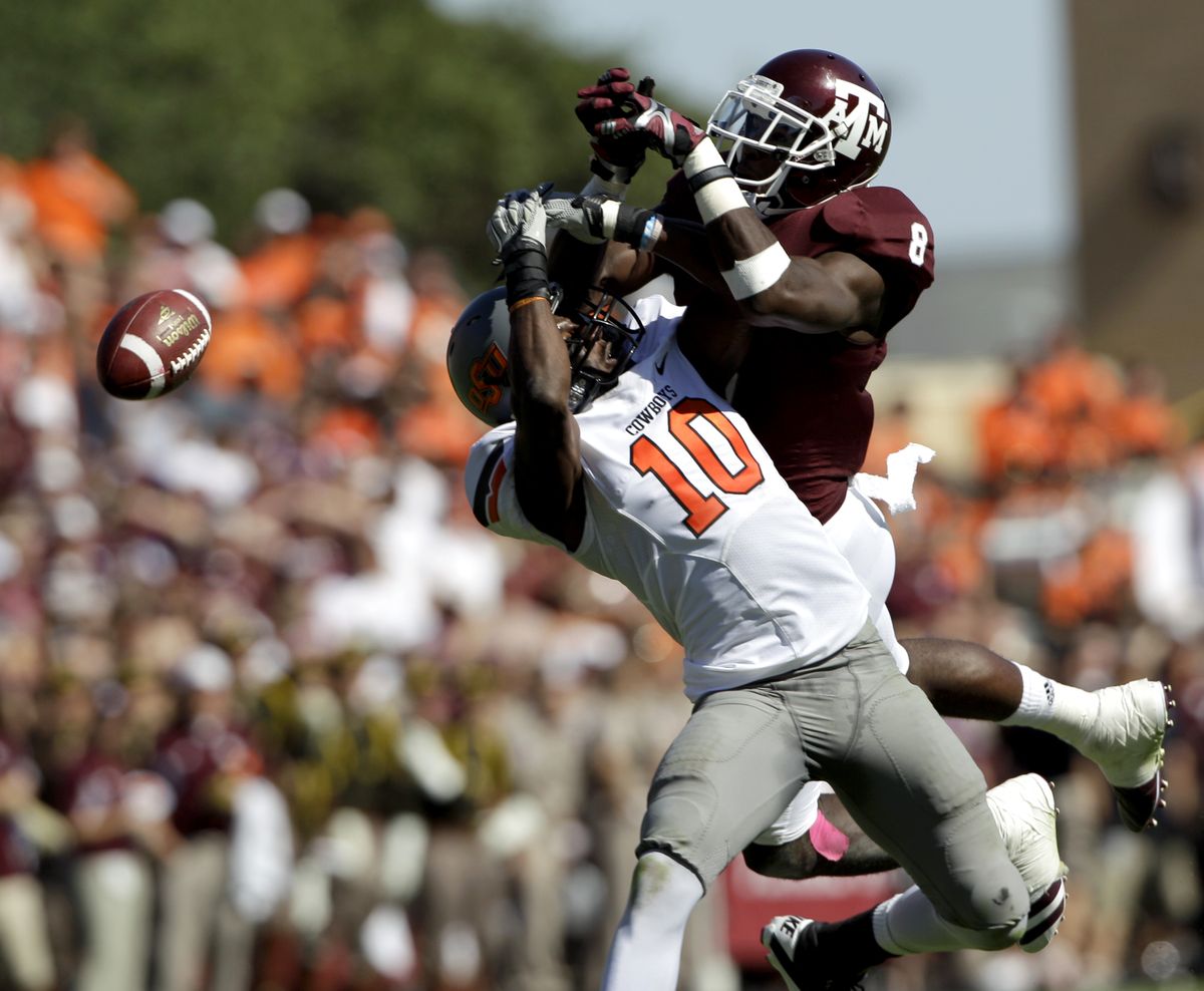 Oklahoma State’s Markelle Martin (10) breaks up a pass intended for Texas A&M receiver Jeff Fuller in Top 10 showdown on Saturday. (Associated Press)