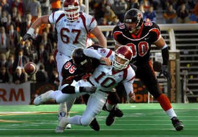 
Washington State quarterback Alex Brink is sacked by Oregon State's Joe Rudulph and fumbles the ball late in the first half. Brink was sacked four times by the Beavers in his first start.
 (Christopher Anderson/ / The Spokesman-Review)
