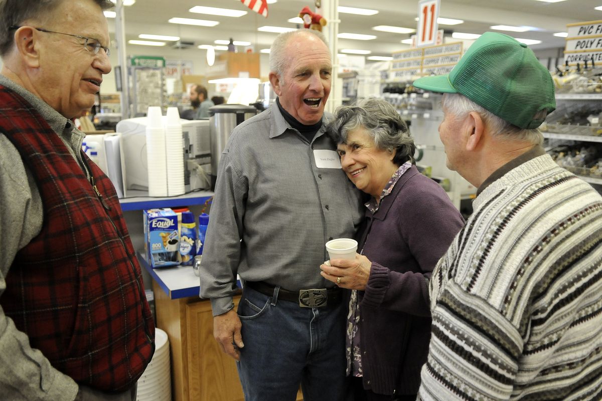 Vern Ziegler gets a hug from Shirley Logan on Tuesday at Ziggy’s on Market Street. Logan, her husband, Kermit, right, and Harlan Douglass were among the customers and friends who shared memories and stories before the building is torn down. (Dan Pelle)