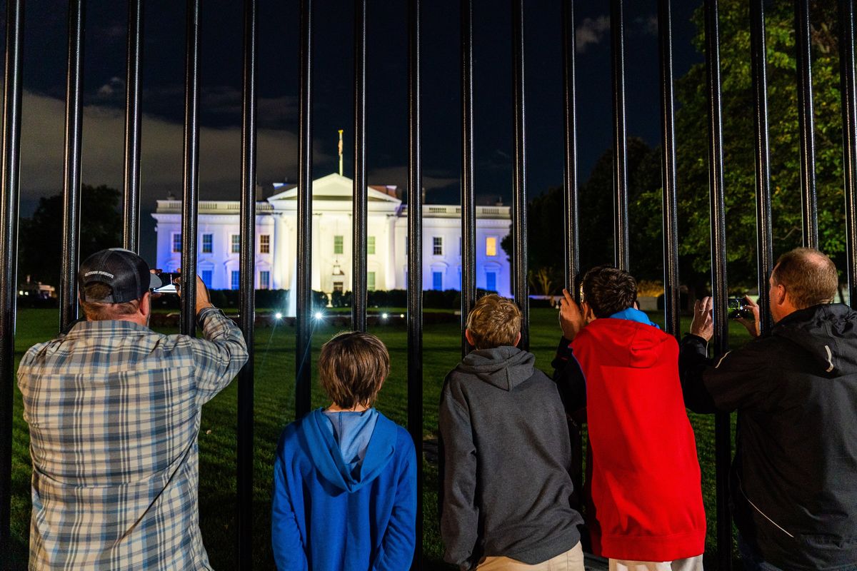 Tourists take photos of the White House lit in blue and white in solidarity with Israel on Oct. 9, one of the two days President Biden was interviewed by special counsel Robert Hur. MUST CREDIT: Demetrius Freeman/The Washington Post  (Demetrius Freeman/The Washington Post)