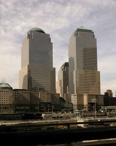 American Express (New York headquarters at right) treats investors well. (Associated Press)