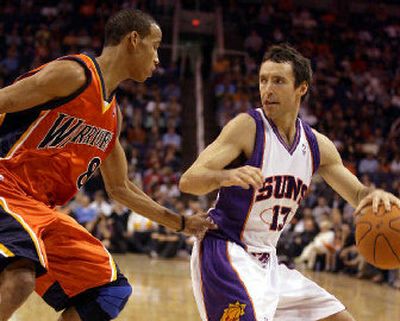 
Phoenix guard Steve Nash, right, gives Golden State's Monta Ellis the runaround in the Suns' 105-101 win. 
 (Associated Press / The Spokesman-Review)