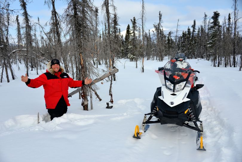 Josh Rindal poses by a marten set in deep snow along the Iditarod Trail on the Kaltag Portage between Kaltag and Unalakleet. Rindal and Bob Jones of Kettle Falls were snowmobiling 1,400-miles along the route of Alaska's famous Iditarod Sled Dog Race in March 2014. (Robert Jones)