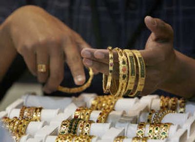 A salesperson shows gold bracelets to a customer. The high price of gold has many jewelers marketing items other than gold to their customers shopping for Valentine's Day gifts.Associated Press
 (Associated Press / The Spokesman-Review)