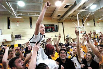 
Team manager Jason McElwain, who has autism, is hoisted by his teammates after his 20-point performance in the closing minutes of a Feb. 15 home game against Spencerport High. 
 (Associated Press / The Spokesman-Review)