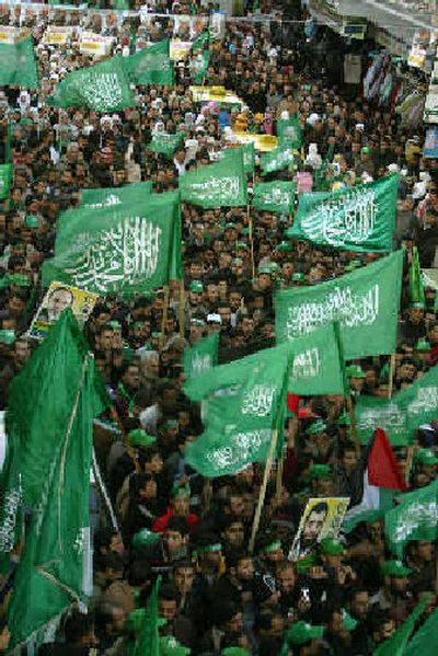 
Palestinian supporters of Hamas celebrate their victory Thursday in parliamentary elections in the West Bank town of Ramallah. 
 (Associated Press / The Spokesman-Review)